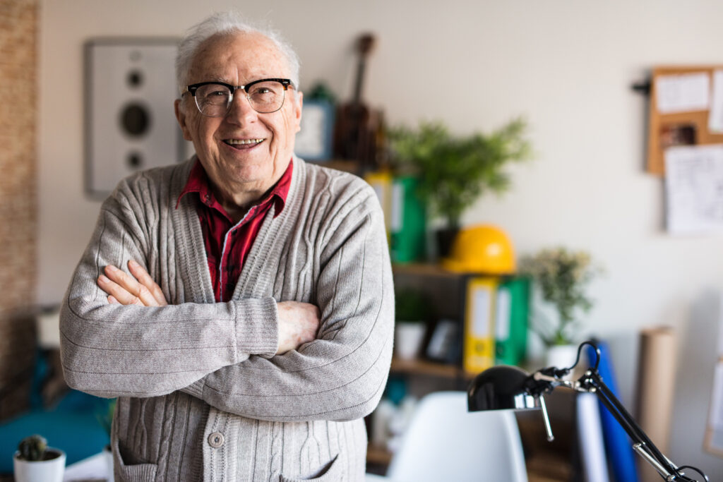 Smiling active senior with arms crossed